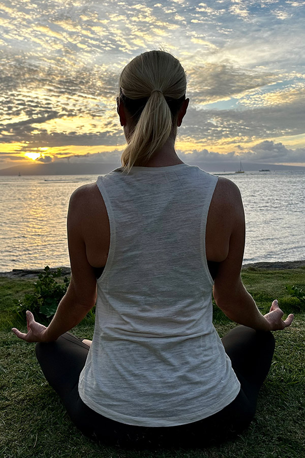 IMG_0188_meditate_crop Meg Urie Rab sitting on lawn in front of an ocean sunset